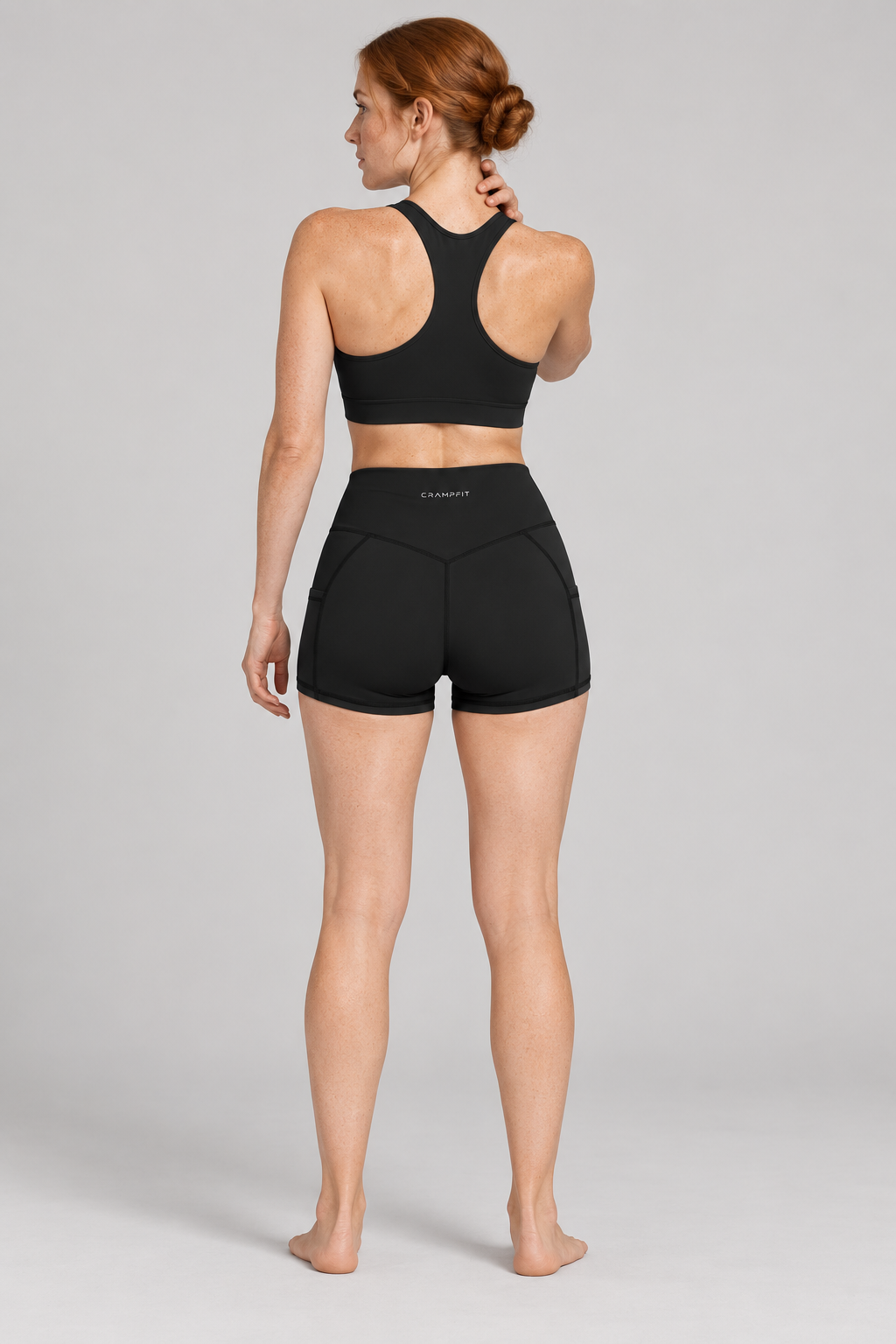 CRAMPFIT Women's High Rise Pocket Yoga Shorts - Black - Back view on model