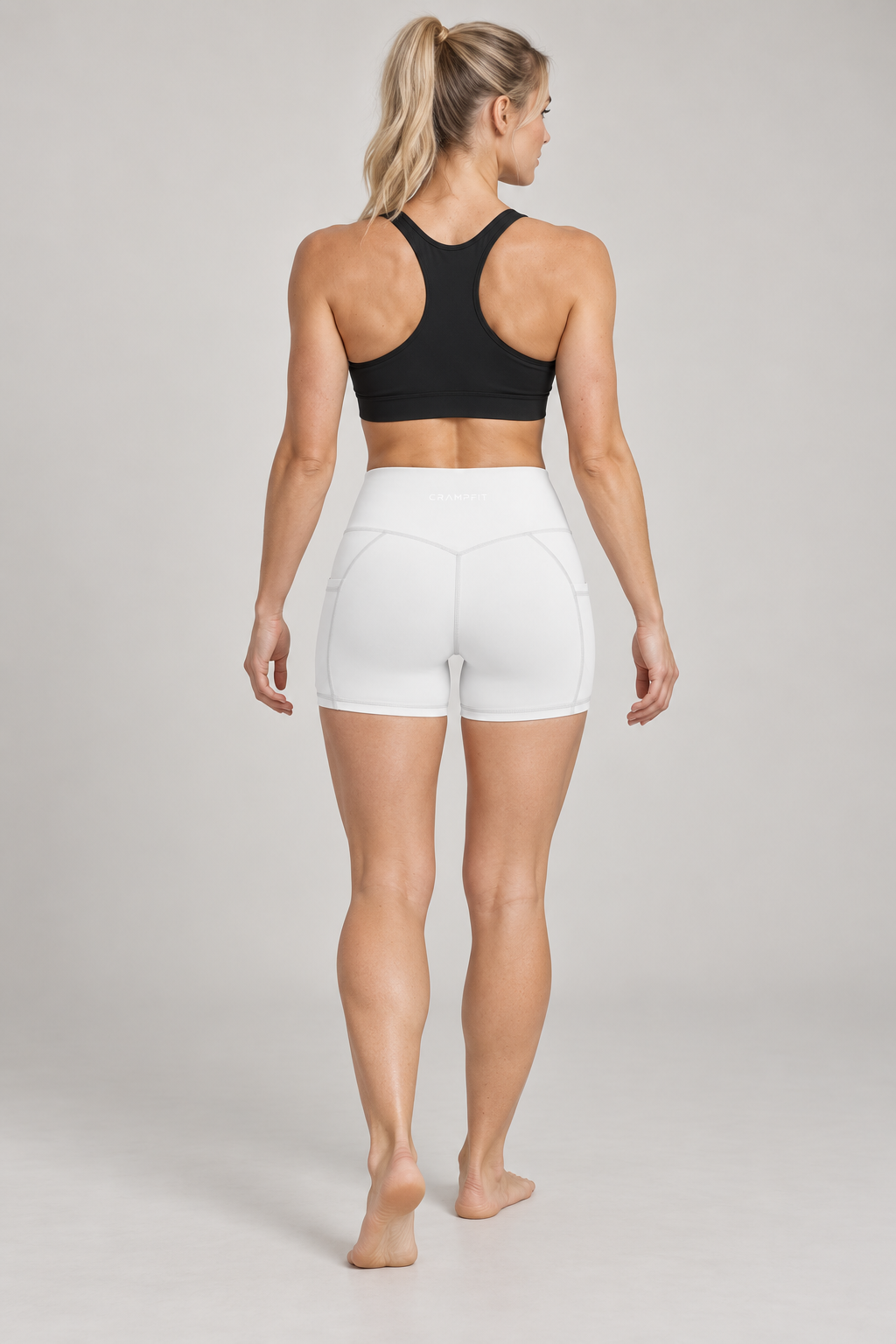 CRAMPFIT Women's High Rise Pocket Yoga Shorts - White - Back view on model