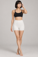 CRAMPFIT Women's High Rise Pocket Yoga Shorts - White - Front view on model
