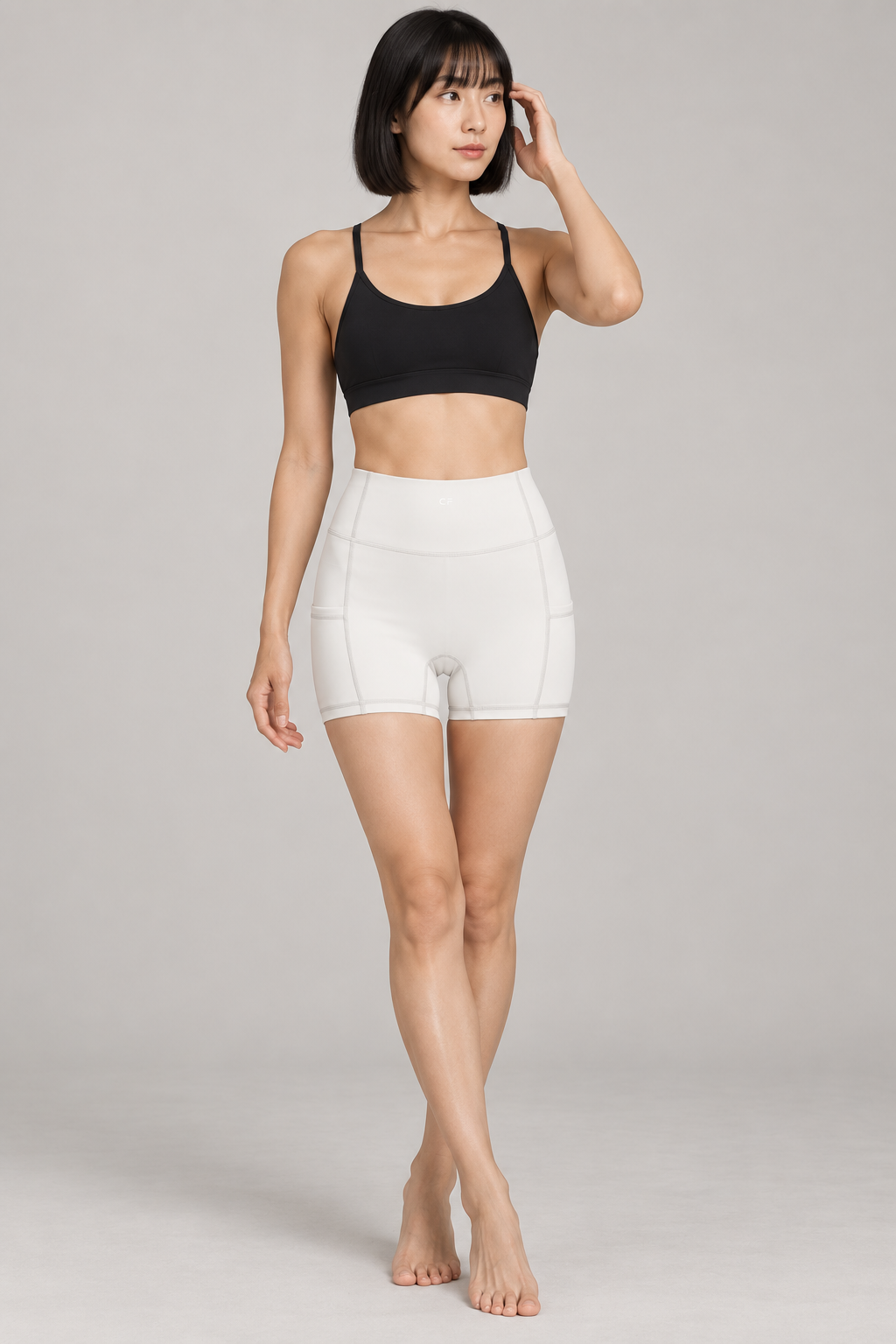 CRAMPFIT Women's High Rise Pocket Yoga Shorts - White - Front view on model