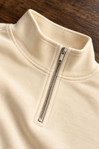 CRAMPFIT Quarter-Zip Crop sweatshirt in cream, stand collar, silver zipper and fabric close-up
