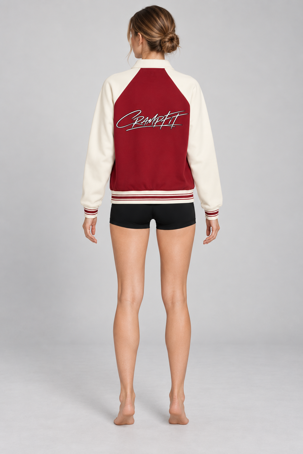 CRAMPFIT Raglan Varsity Jacket in burgundy and cream, back logo view on a slim female model