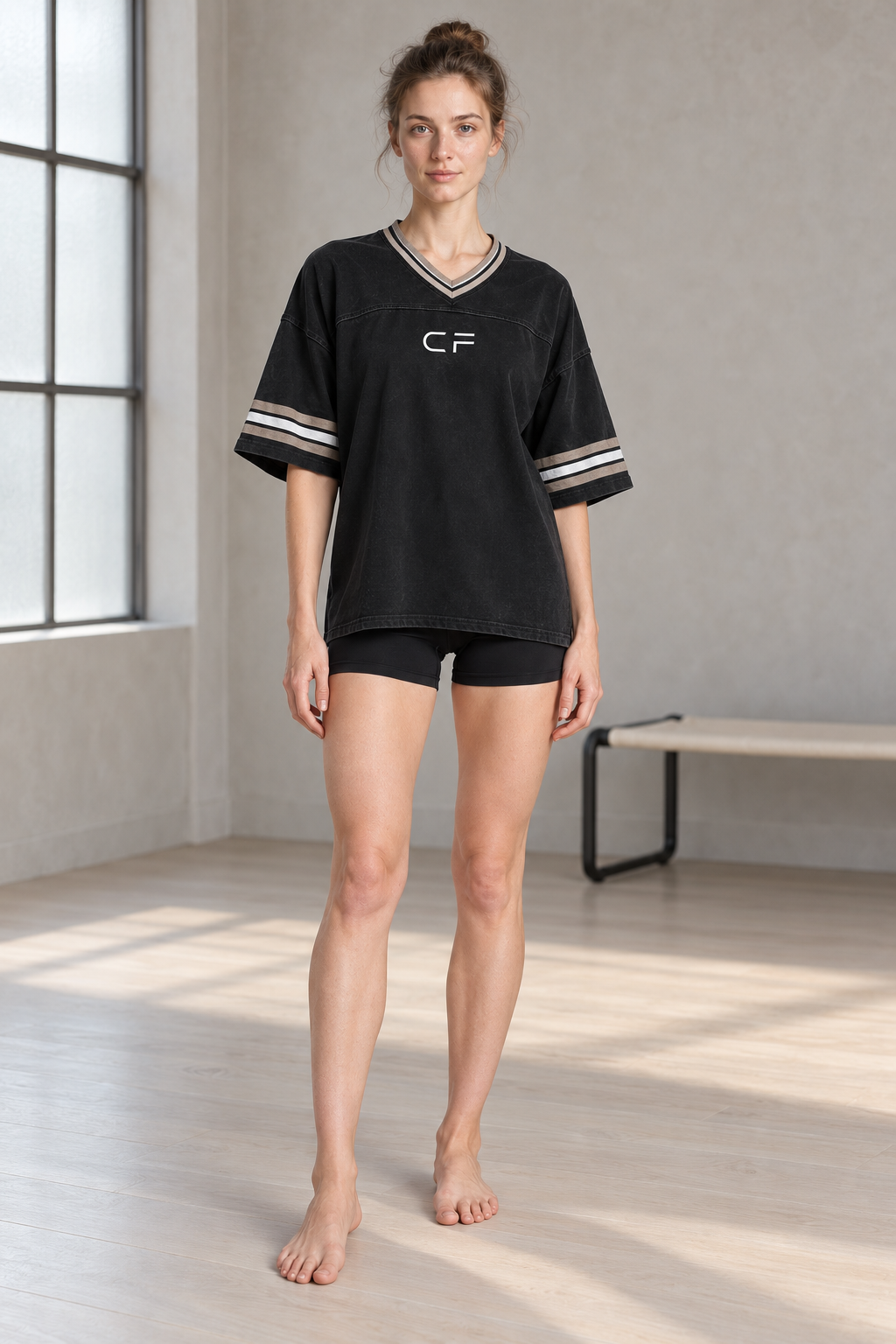 CRAMPFIT women's black boxy jersey, full-body front view showing V-neck, striped sleeves and relaxed fit.