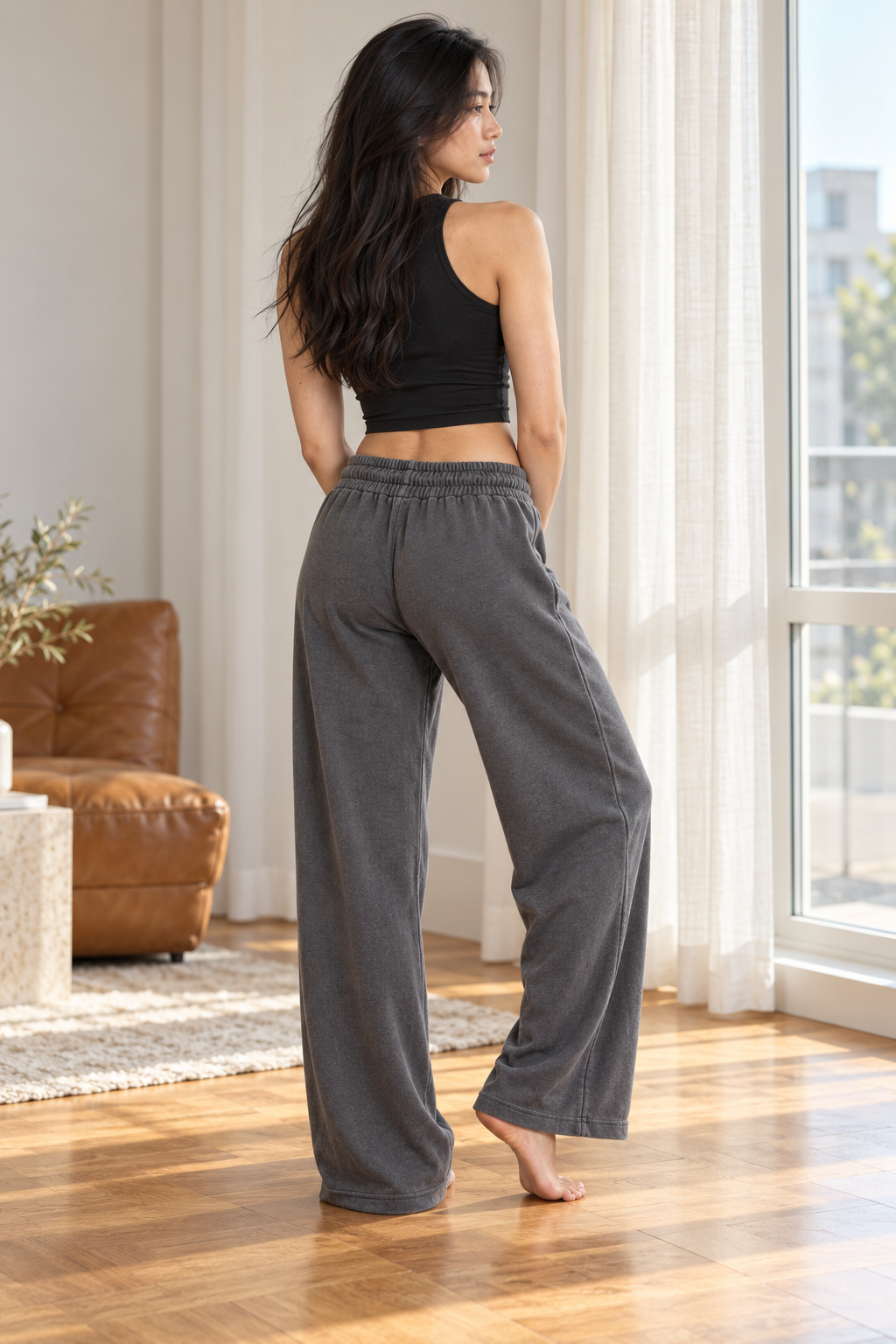 CRAMPFIT dark gray sweatpants, rear three-quarter view showing the open hems.