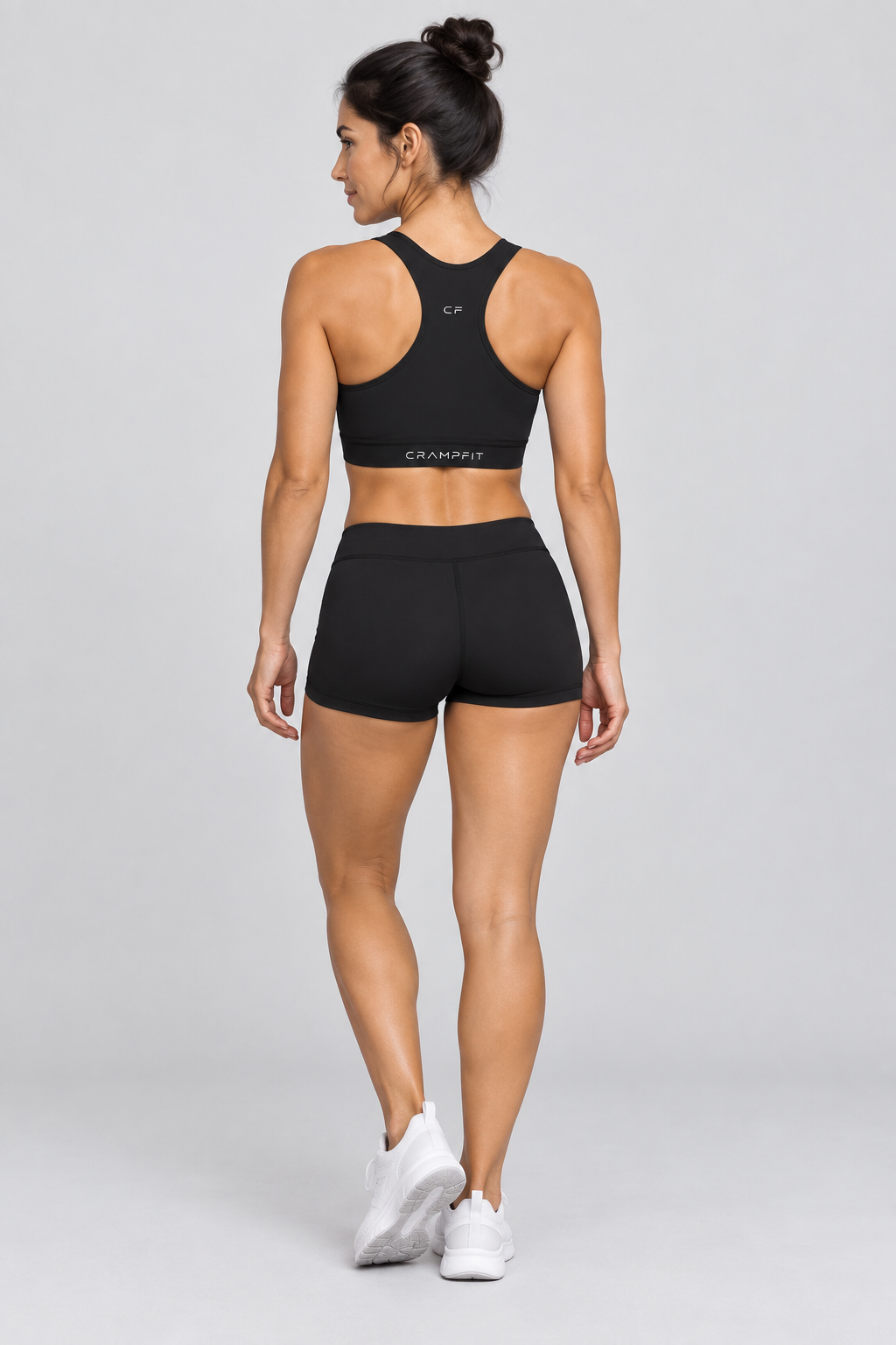 CRAMPFIT Women's Cropped Sports Bra - black back view with black workout shorts