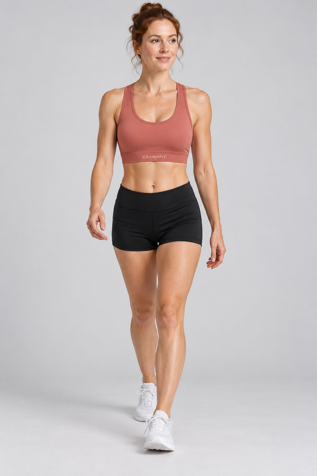 CRAMPFIT Women's Cropped Sports Bra - brick red front view with black workout shorts