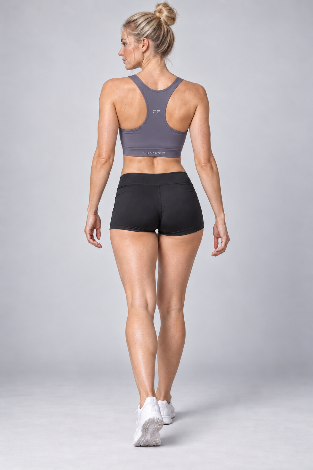 CRAMPFIT Women's Cropped Sports Bra - dark purple back view with black workout shorts