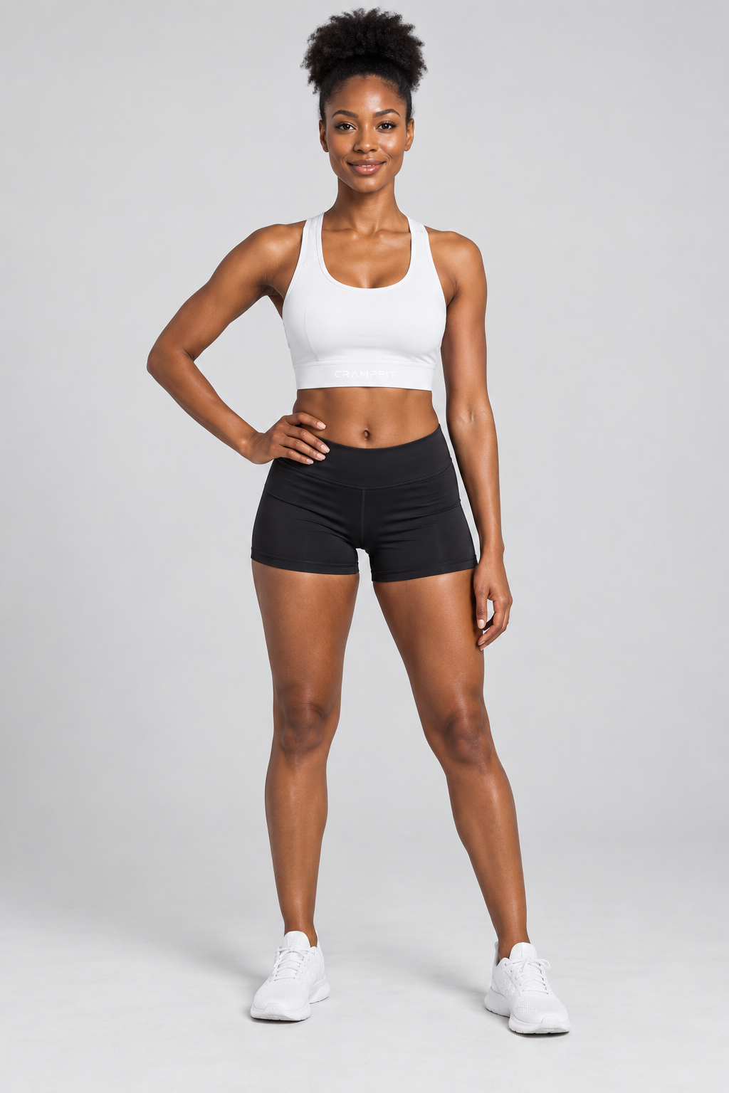 CRAMPFIT Women's Cropped Sports Bra - white front view with black workout shorts