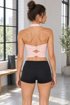 Rear view of the light pink CRAMPFIT halter yoga sports bra showing the neck strap, gathered back and diamond-shaped opening.