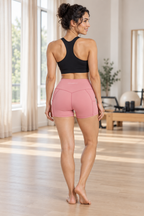 CRAMPFIT women's high-rise pocket yoga shorts in pink, back view showing the contoured seams and smooth rear panels.