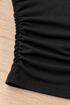 CRAMPFIT women's ruched yoga tube top in black, close-up of the side gathering, fabric texture and stitched hem.