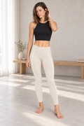 CRAMPFIT women's cream Sculpt Legging, full-body front view showing high-rise fit and white contour piping, styled with a black crop tank.