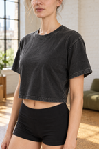 Close-up of CRAMPFIT black crop tee showing washed cotton texture, crewneck and sleeve stitching.