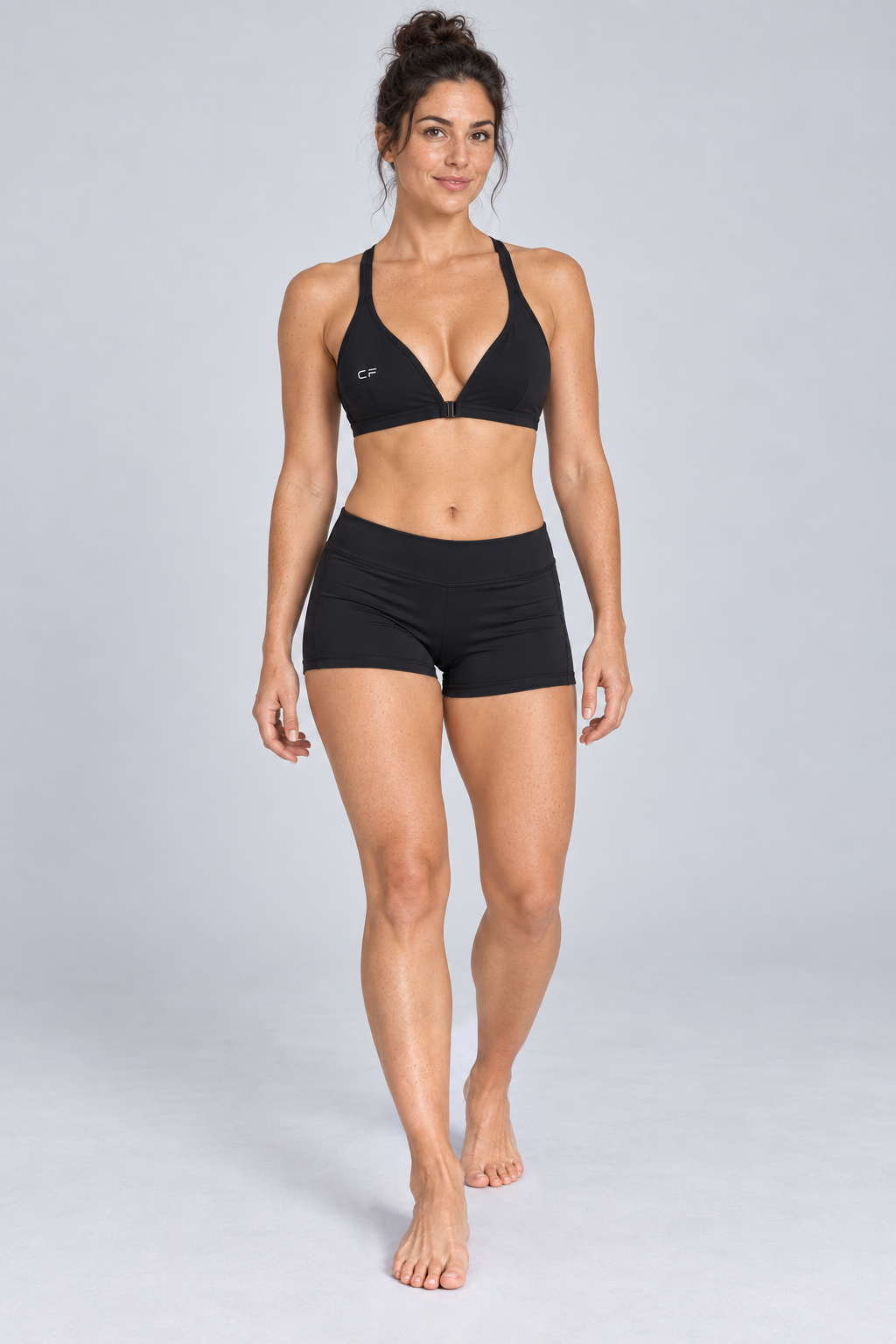 CRAMPFIT Women's Yoga Sports Bra - black front view, barefoot, styled with black workout shorts