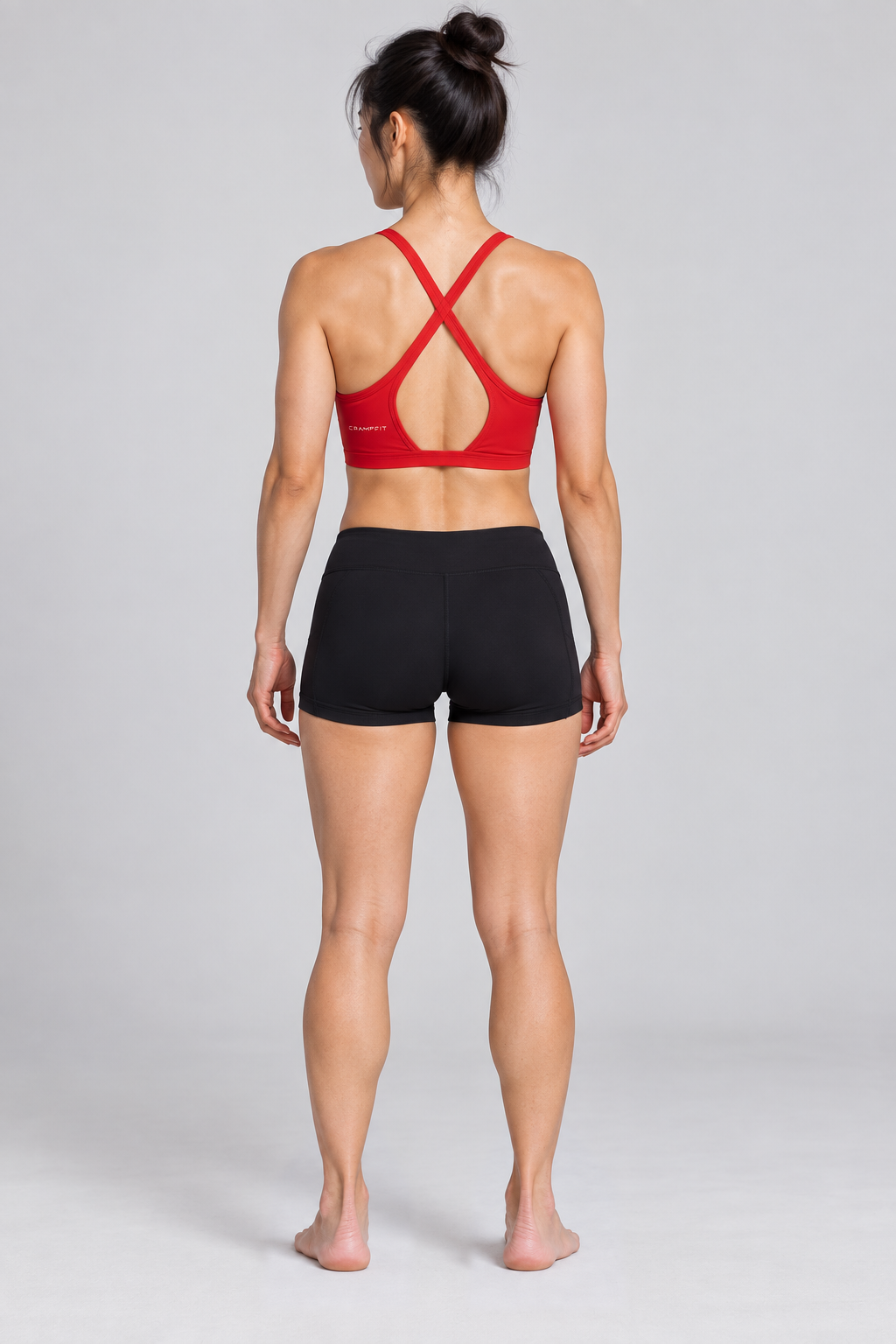 CRAMPFIT Women's Yoga Sports Bra - red back view, barefoot, styled with black workout shorts